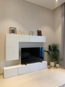 a living room with a fireplace with a tv at Beach front 414 villa private pool in Muscat