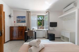 a bedroom with a bed and a desk and a window at Villa Anna in Meta