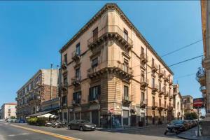 a building on a city street with cars parked in front at DS Apartment in Catania