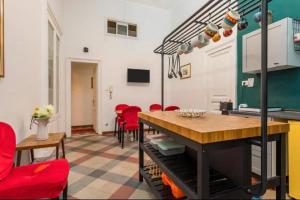 a living room with a table and red chairs at DS Apartment in Catania