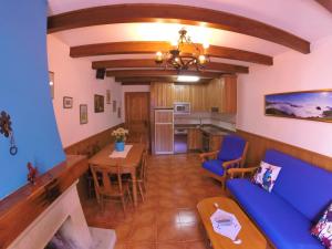 a living room with a blue couch and a table at Viviendas Rurales El Cantón in Cucayo