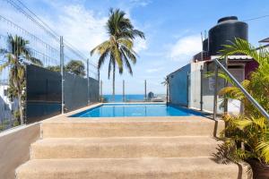 a swimming pool on the side of a house with stairs at Bungalows Yeah Los Ayala in Los Ayala