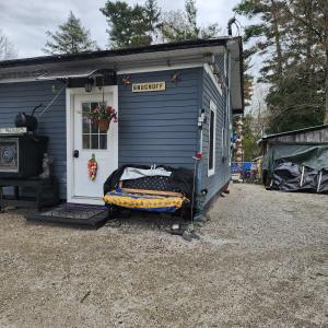 a small blue house with a bed in front of it at Snugnuff in South Burlington