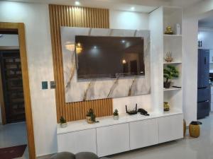 a living room with a large television on a wall at Beautiful View Apartment in San Pedro de Macorís
