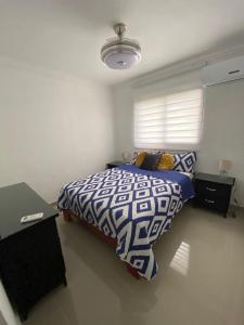 a bedroom with a bed and a table and a window at Beautiful View Apartment in San Pedro de Macorís +17 photos