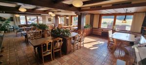 a restaurant with tables and chairs in a room at Auerhahn Bed and Breakfast - Black Forest - Waldhotel in Eisenbach +23 photos
