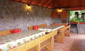 a room with two beds and a kitchen in it at Erika Apartman in Balatonlelle