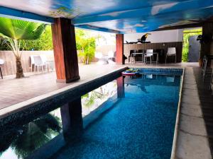 a swimming pool with blue water in a house at O'soho GarDens BingerVille in Bingerville
