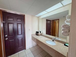a bathroom with a sink and a large mirror at Landmark Inn On The River Sevierville in Sevierville +13 photos