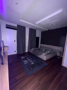 a bedroom with a bed and a rug on the floor at Alexa Smart Home One Bedroom Luxury Apartment in Lekki