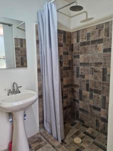 a bathroom with a shower curtain and a sink at Casa del Horno in El Cinco de Mayo +26 photos