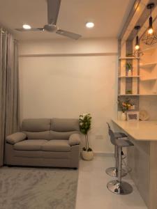 a living room with a couch and a table at Bougainvillea Breeze in Male City