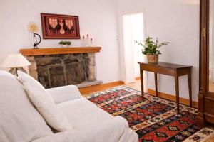 a living room with a white couch and a fireplace at La Vignaredda - Residenza di Charme in Aggius