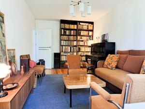 a living room with a couch and a table at Cozy Vintage Apartment in Klaipėda