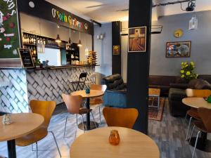 a restaurant with tables and chairs and a bar at O'soho GarDens BingerVille in Bingerville