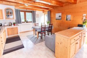 a kitchen and dining room with a table and chairs at Casa Bruna Valmalenco, Casa vacanze sopra Caspoggio in Caspoggio