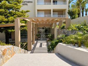 a building with a walkway in front of it at Eleftheria Hotel in Agia Marina Nea Kydonias +56 photos
