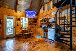a kitchen with a stove and a table in a cabin at Riverview Cabin in Helen