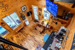 an overhead view of a living room with a television in a cabin at Riverview Cabin in Helen