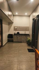 a large kitchen with a cat sitting on a counter at KRS PARADISE premium suite room in Tiruvannāmalai