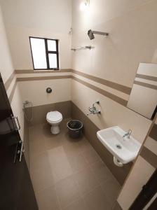 a bathroom with a sink and a toilet at Shyams homestay MV in Malpe