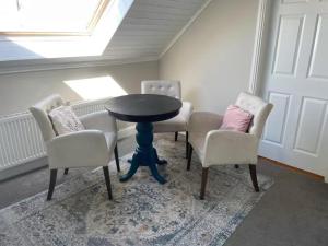 a dining room with a table and four chairs at Wild Atlantic View in Walshestown