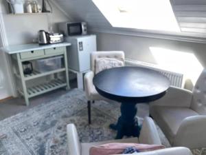 a living room with a table and chairs at Wild Atlantic View in Walshestown