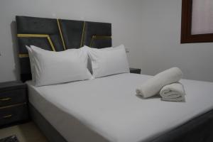 a white bed with a stuffed animal on it at Studio MLK in Chefchaouen