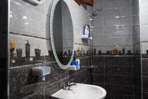 a bathroom with a sink and a mirror at Studio MLK in Chefchaouen