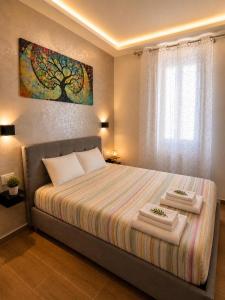 a bedroom with a bed with a tree painting on the wall at Sogni Di Luna in Scandicci