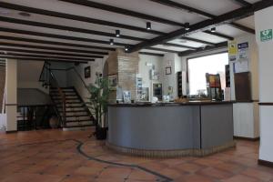 a lobby with a bar in the middle of a building at La Posada del Conde in Ardales