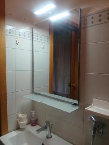 a bathroom with a mirror above a sink at Casa vacanze Marestella in Le Grazie +32 photos