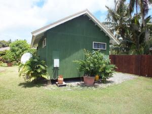 a green house with plants in front of it at Are Moe in Rarotonga