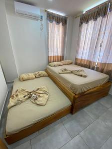 コヒミエスにあるCojimies Suiteのカーテン付きの部屋にツインベッドが2台