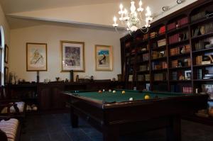 a billiard room with a pool table and books at Pueblo Canyon Inn in Los Alamos