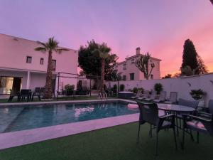 a villa with a swimming pool with a table and chairs at Mediterranean Moon House in Alicante