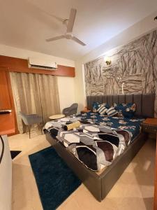 a bedroom with a bed and a ceiling fan at Hare Krishna Orchid Society in Vrindāvan