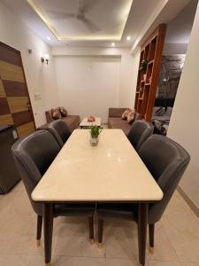 a conference room with a table and chairs at Hare Krishna Orchid Society in Vrindāvan
