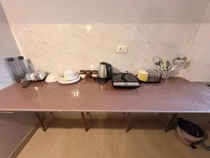 a table with a counter top with utensils on it at Hare Krishna Orchid Society in Vrindāvan