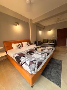 a bedroom with a large bed in a room at Hare Krishna Orchid Society in Vrindāvan +9 photos