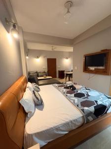 a bedroom with a large bed in a room at Hare Krishna Orchid Society in Vrindāvan