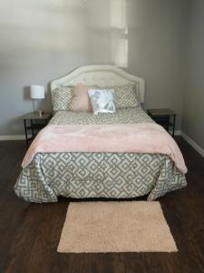 a bed with a pink blanket and pillows on it at Whole House All Yours! in Cocoa