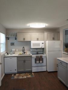 a kitchen with white appliances and a white refrigerator at Whole House All Yours! in Cocoa