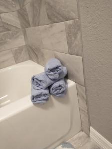 a pile of towels sitting on the edge of a bath tub at Whole House All Yours! in Cocoa +26 photos