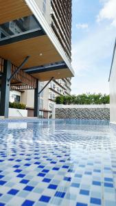 a swimming pool with blue tiles on the floor of a building at The View at 34th - Sunset Skyline Suite Near SM J Mall & Fiber Wifi in Mandaue City