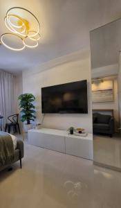 a living room with a large tv on the wall at The View at 34th - Sunset Skyline Suite Near SM J Mall & Fiber Wifi in Mandaue City