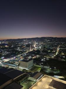 a view of a city at night with lights at The View at 34th - Sunset Skyline Suite Near SM J Mall & Fiber Wifi in Mandaue City