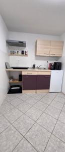 a kitchen with a sink and a tiled floor at Koča Martuljek in Gozd Martuljek +17 photos