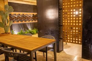 a dining room with a wooden table and chairs at 7 Casa Laurel Hotel Boutique in Oaxaca City