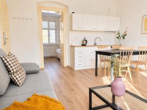 a living room with a table and a kitchen at Villa Medica in Kraslice +74 photos